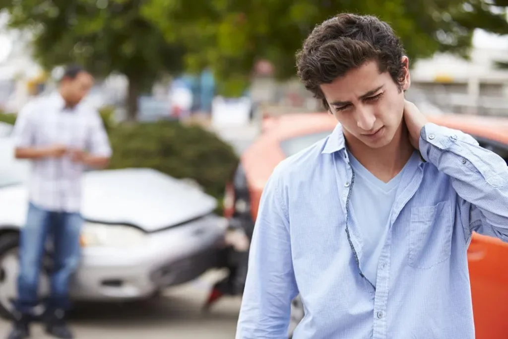 A young man after a car accident, maybe with whiplash. He needs auto accident injury treatment at Crystal Springs.