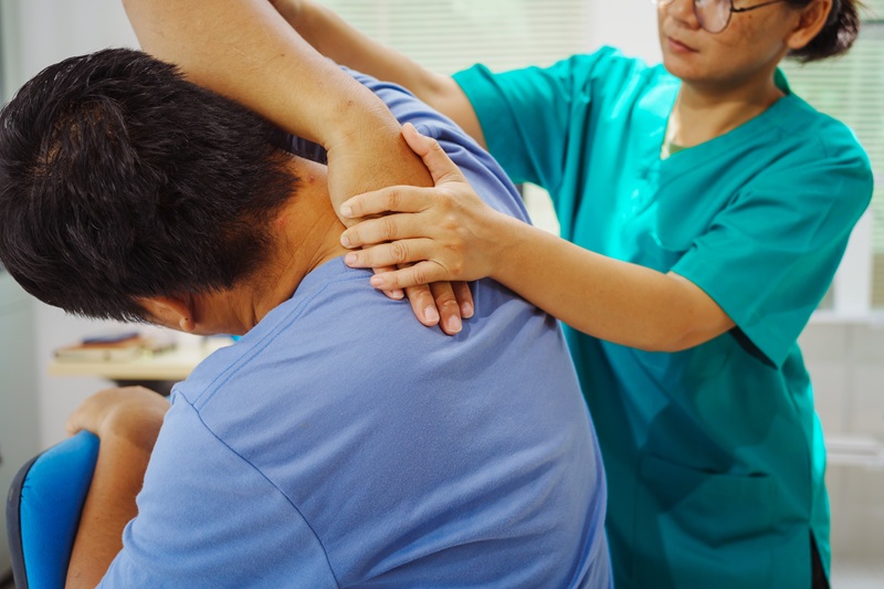 A patient doing stretches and mobility to help with frozen shoulder.
